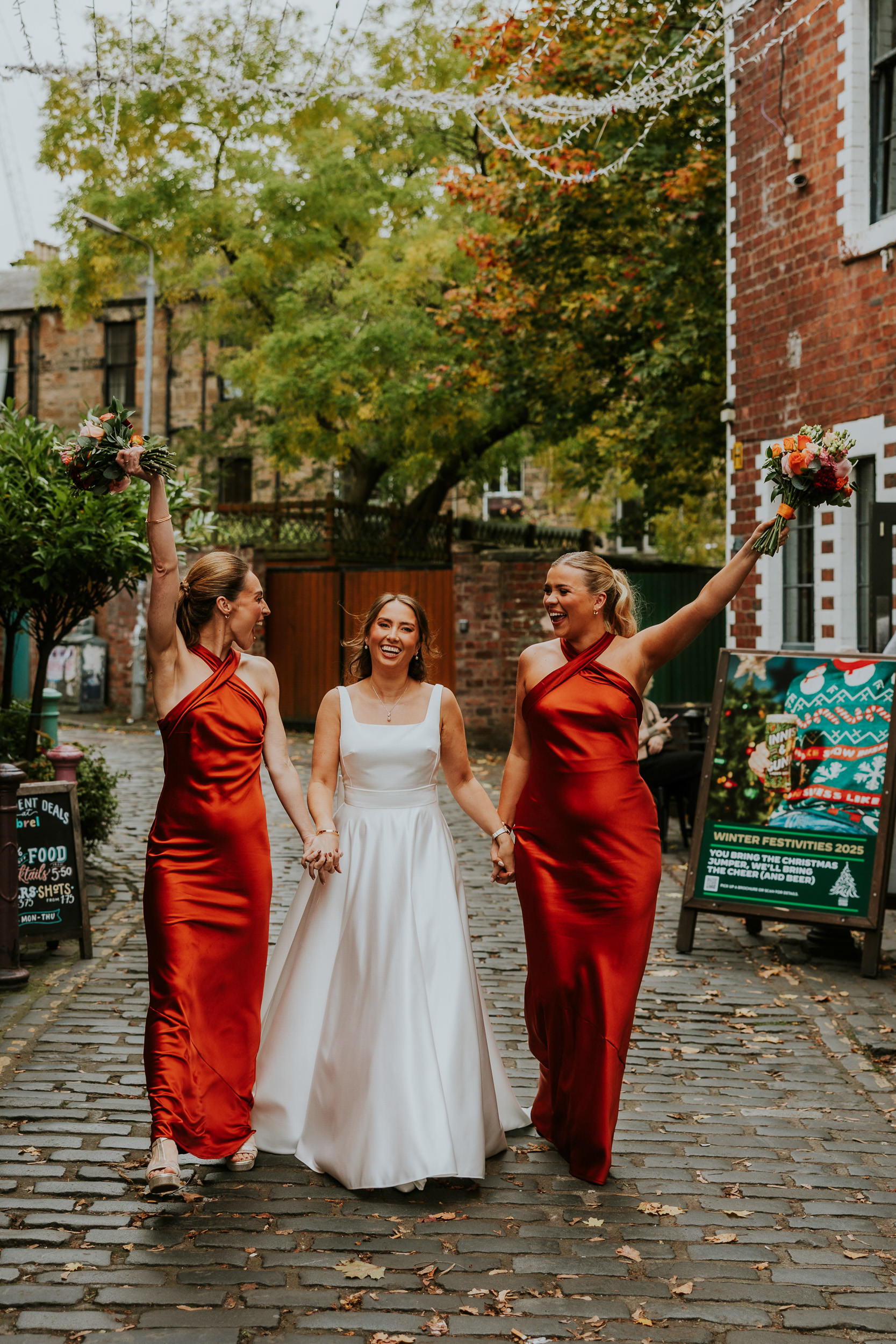 Bride and Bridesmaids throwing their flowers in the air at Ubiquitous Chip