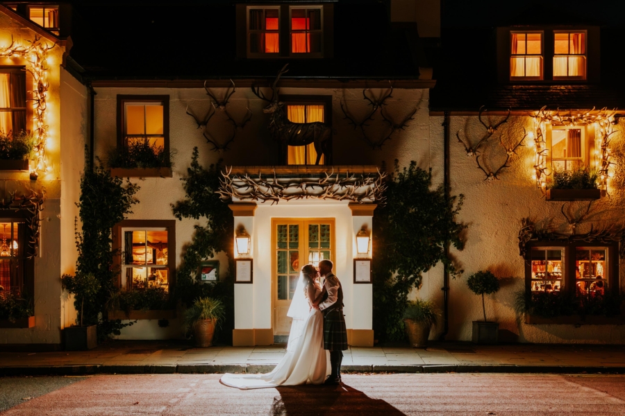 Bride and Groom outside Loch Lomond Arms Hotel at night