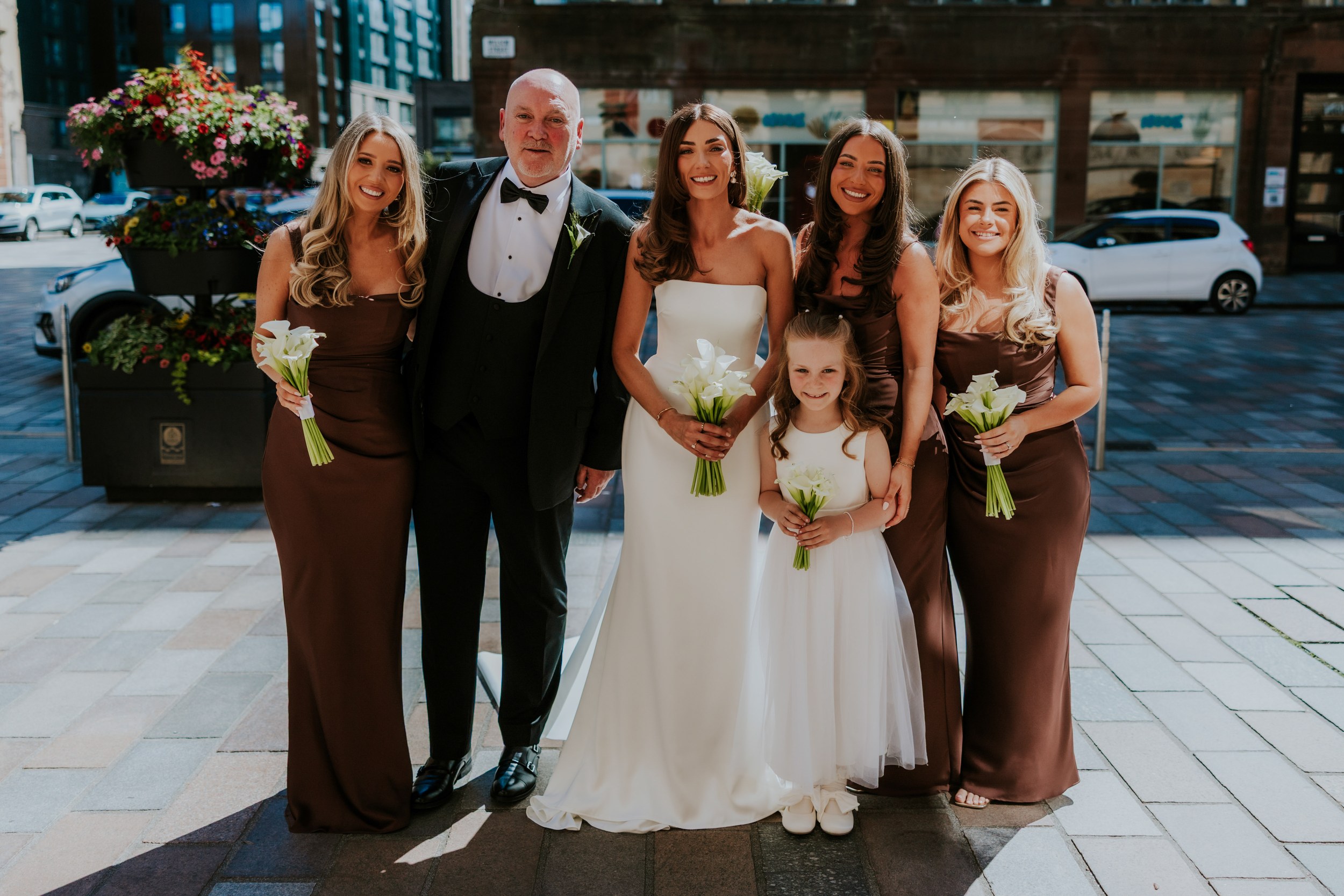 Citation Glasgow wedding photographer 21 Bride and attendants holding calla lily bouquets posed outside Citation Glasgow in Glasgow city centre.