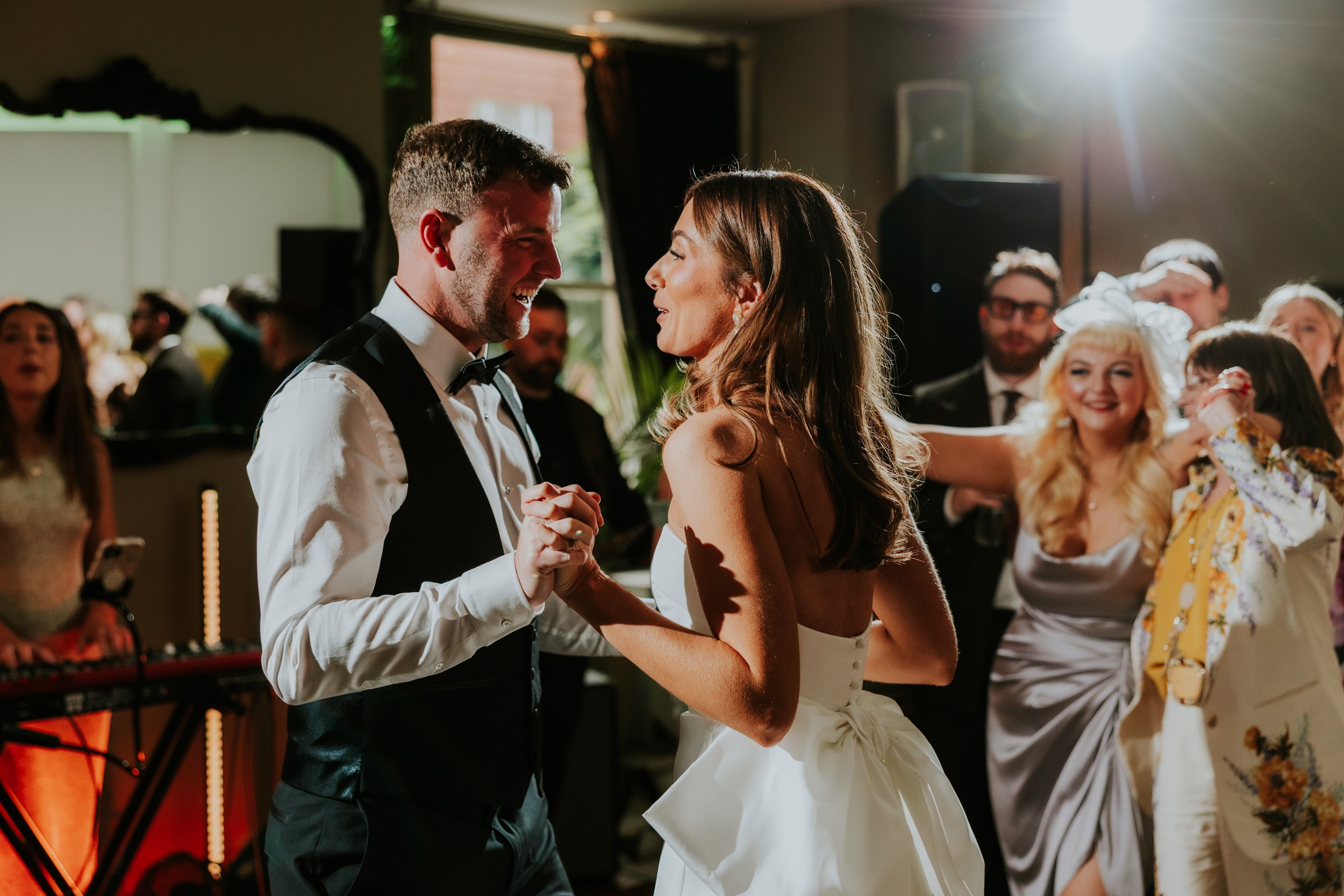 Citation Glasgow wedding photographer 78 Bride and groom dancing at an indoor wedding reception with guests watching and smiling.