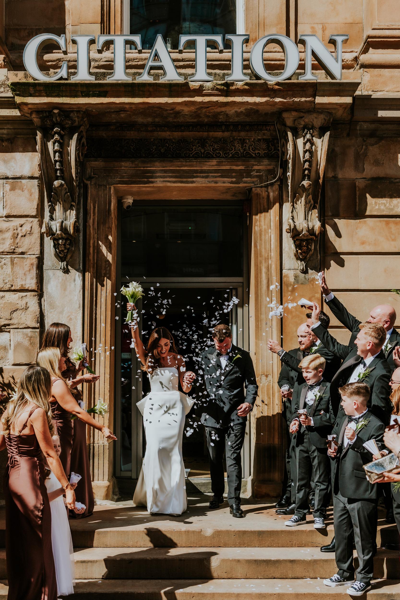Citation Glasgow wedding photographer 39 Bride and groom exit under 'CITATION' sign as confetti is thrown outside Citation Glasgow.