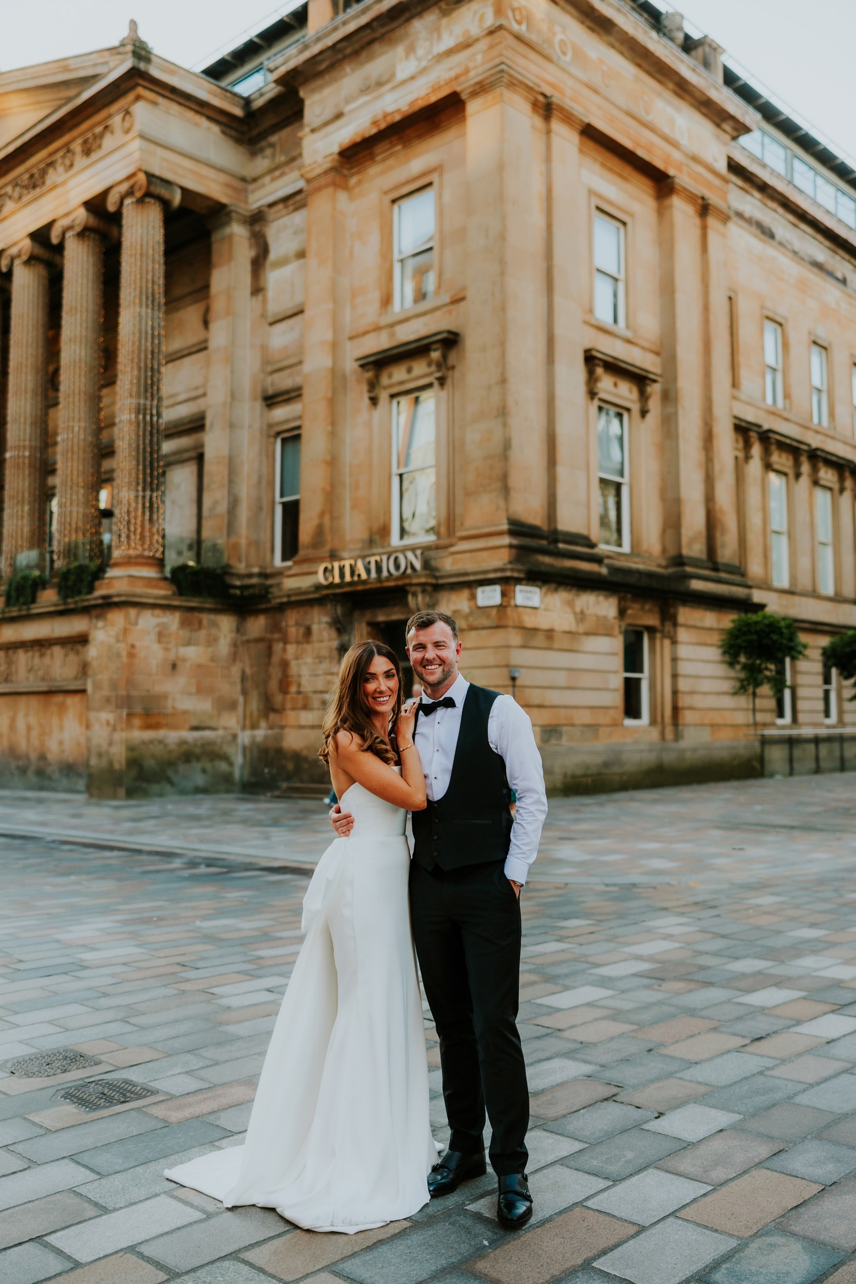 Citation Glasgow wedding photographer 95 Bride and groom smiling outside the Citation building in Glasgow.