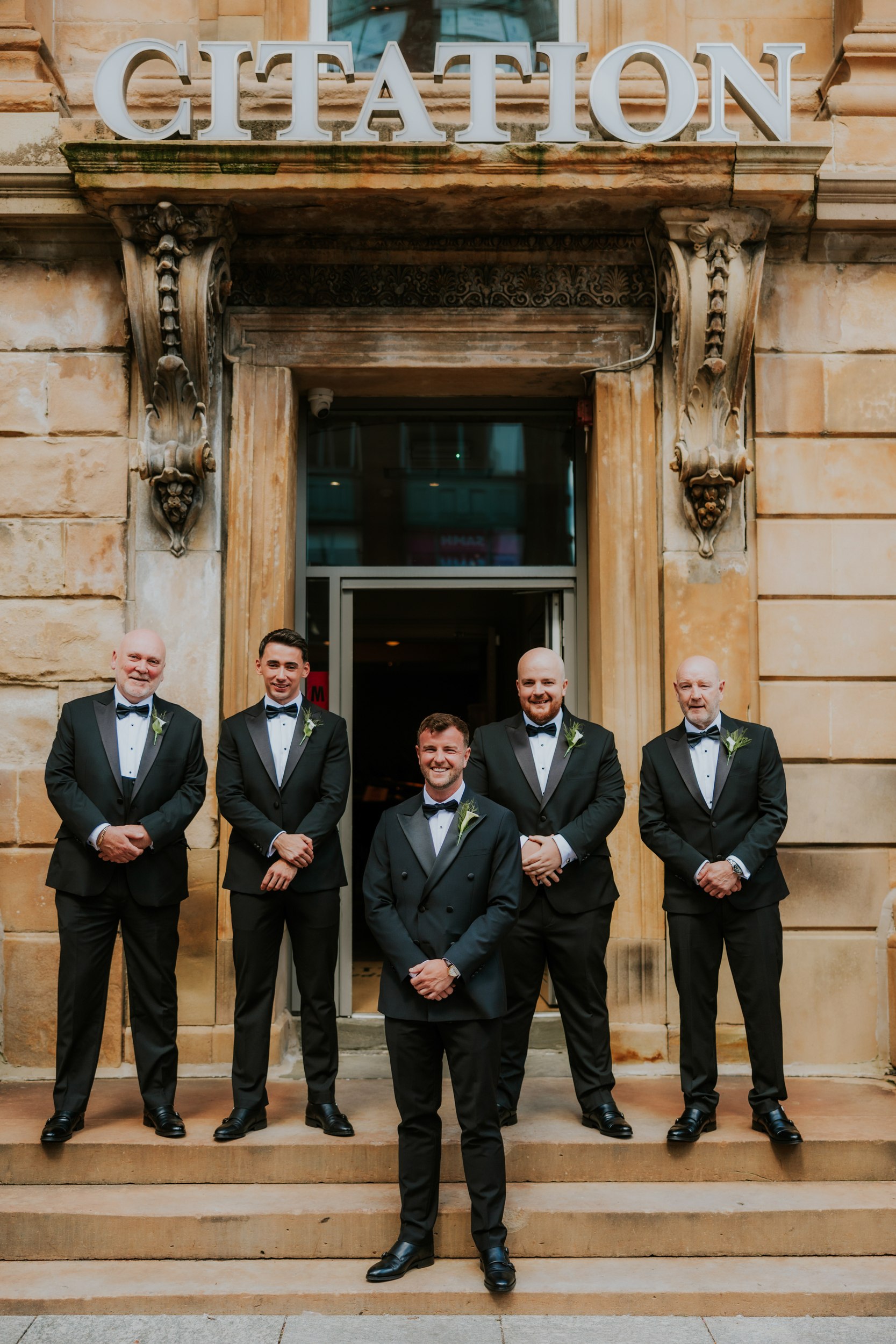 Citation Glasgow wedding photographer 9 Groom and four groomsmen in tuxedos on stone steps under the 'Citation' entrance sign.