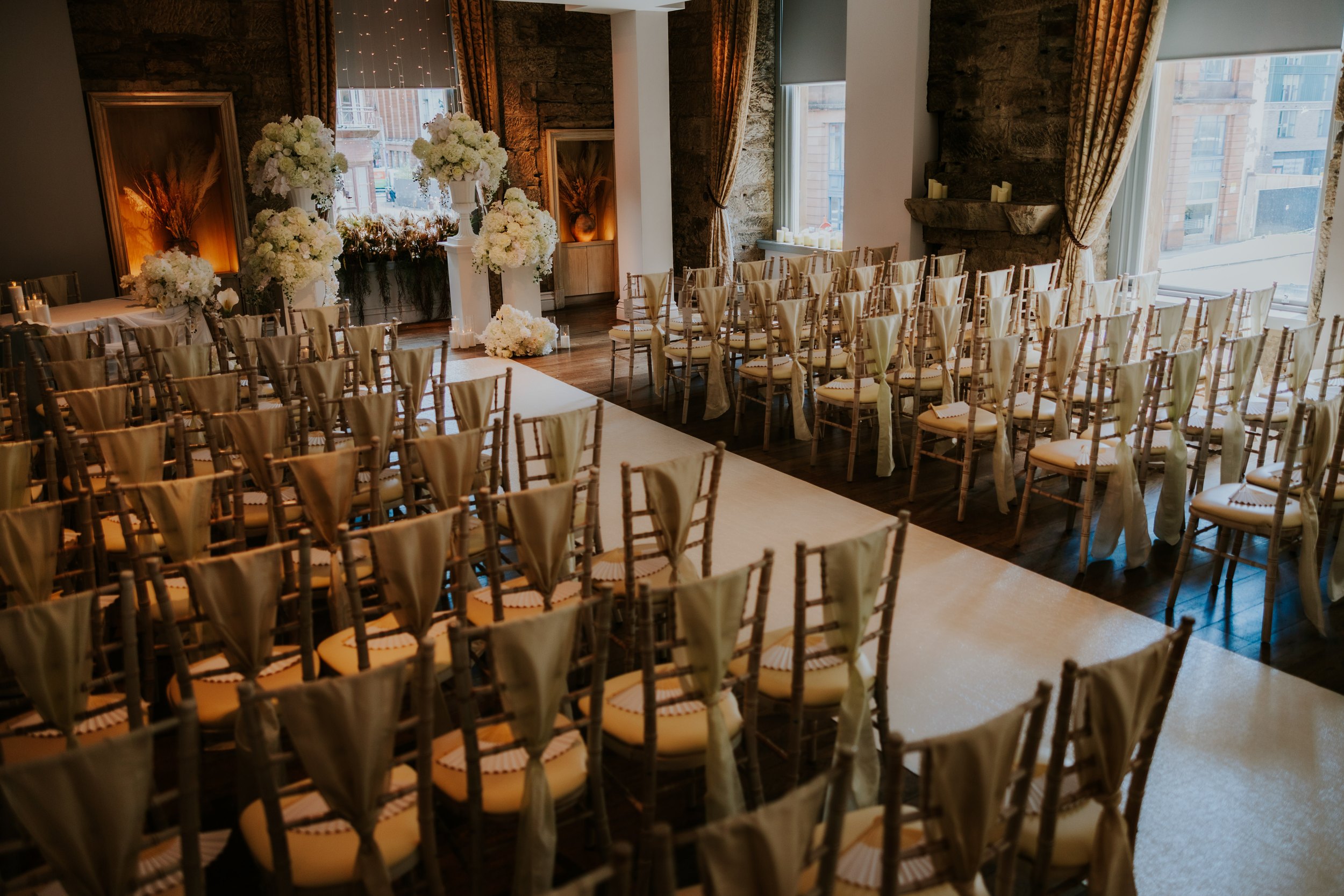 Citation Glasgow wedding photographer 3 Wedding ceremony room at Citation Glasgow with aisle, cream chiavari chairs and tall white floral arrangements.