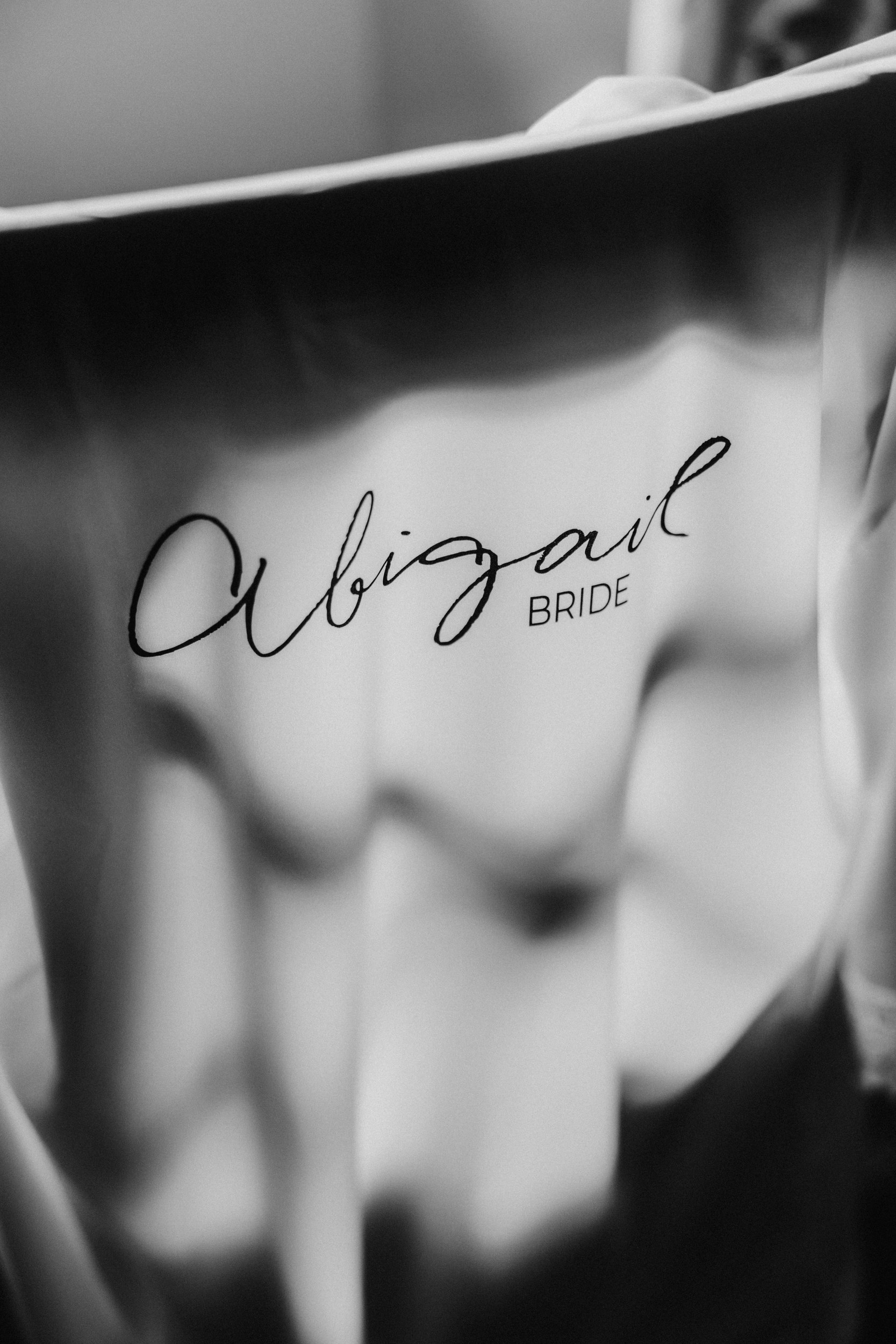 Close-up of a garment printed with the name "Abigail" above the word "BRIDE".