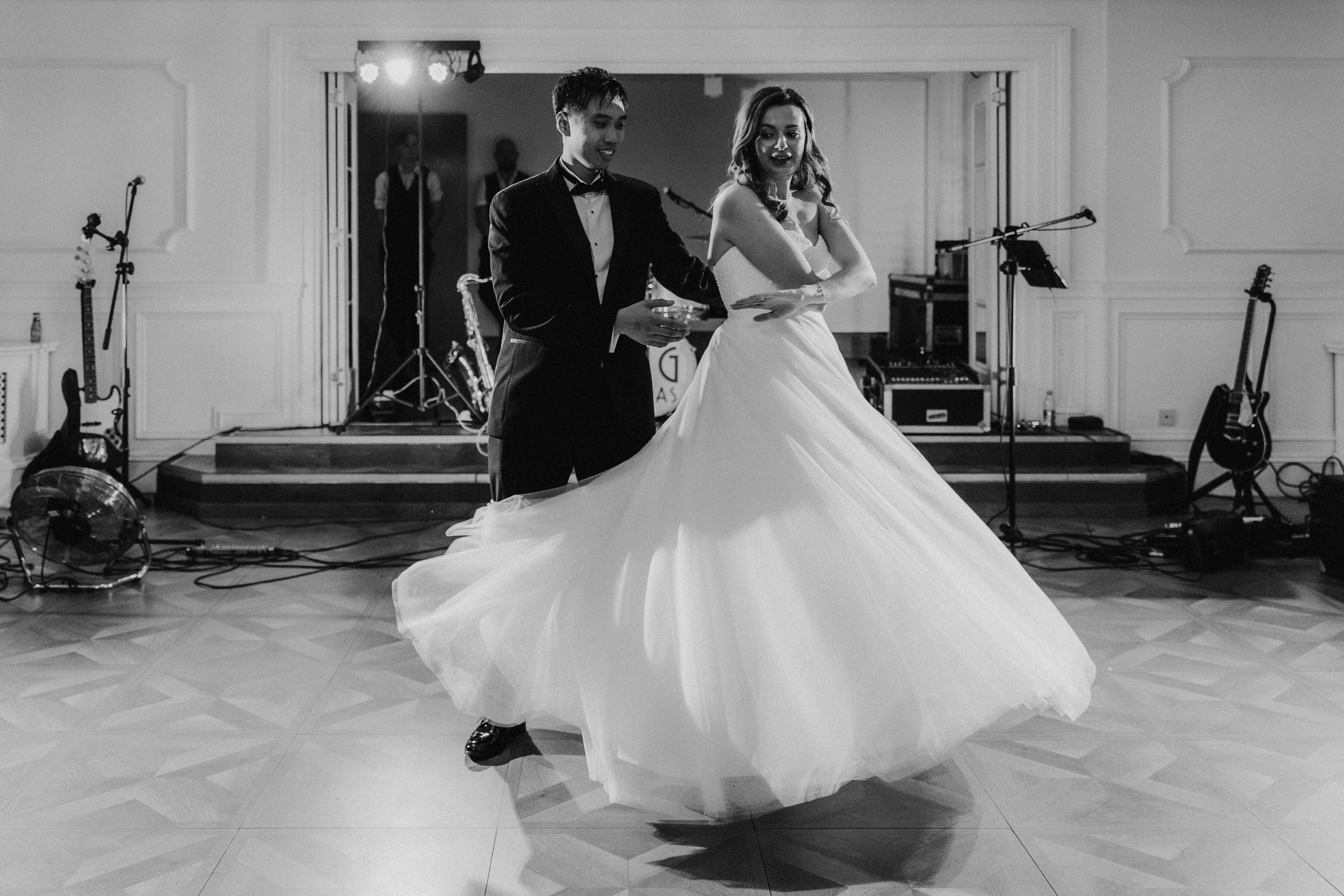 Emma and Gordon dancing at Lochgreen House Hotel, her wedding dress swirling, in black and white.