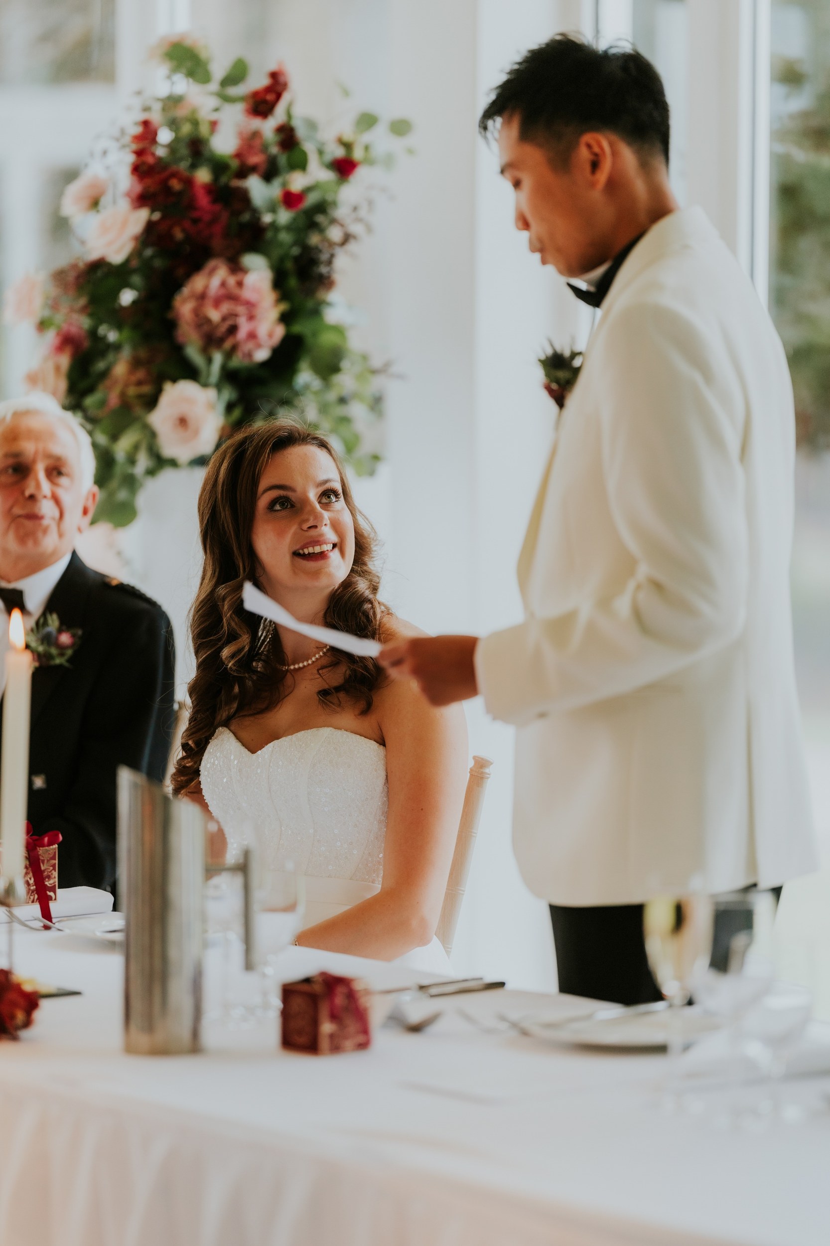 Emma smiles up at Gordon as he gives his speech at Lochgreen House Hotel.