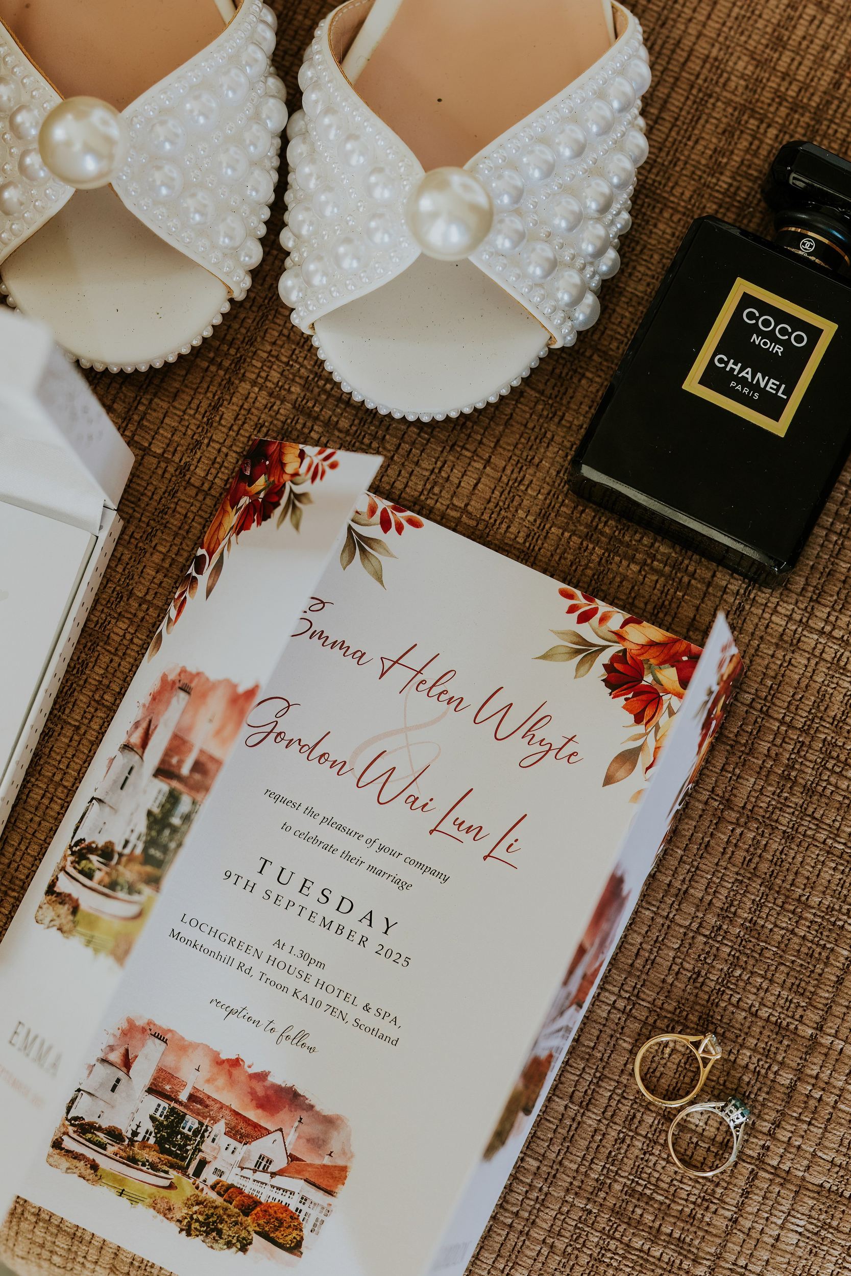 Pearl-embellished bridal shoes, Chanel perfume and two rings beside Emma and Gordon’s illustrated wedding invitation.